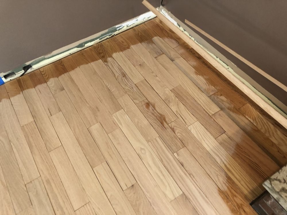 A wooden floor with some brown wood on it